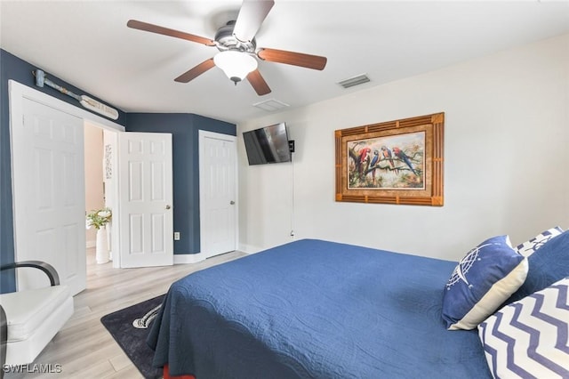 bedroom with a closet, ceiling fan, and light hardwood / wood-style flooring