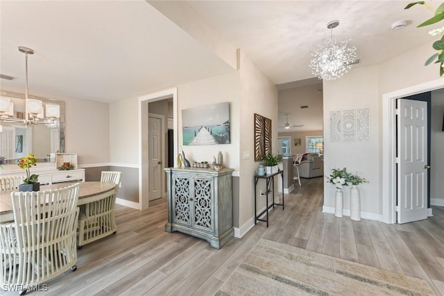 hallway featuring an inviting chandelier and light wood-type flooring