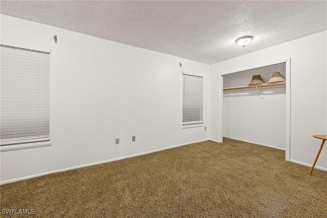 unfurnished bedroom with carpet, a textured ceiling, and a closet