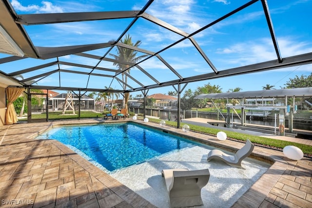 view of pool featuring a water view, glass enclosure, and a patio area