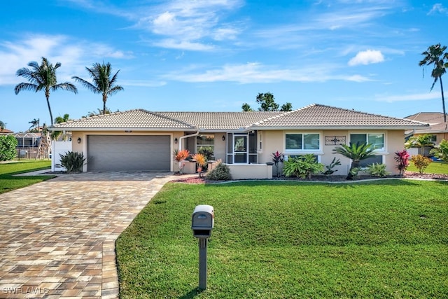 single story home with a garage and a front lawn