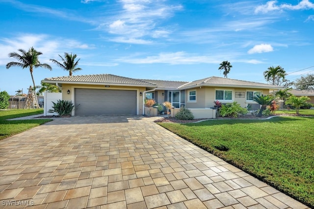 single story home featuring a garage and a front yard