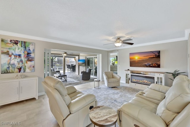 living room with ornamental molding, a textured ceiling, and ceiling fan