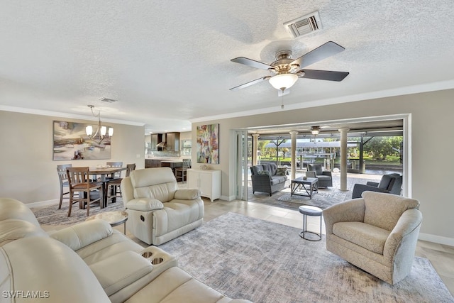 living room with crown molding, ceiling fan with notable chandelier, and a textured ceiling