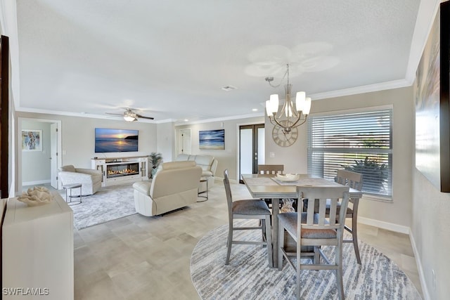 dining area featuring ornamental molding and ceiling fan with notable chandelier