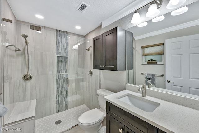 bathroom featuring vanity, an enclosed shower, crown molding, and toilet