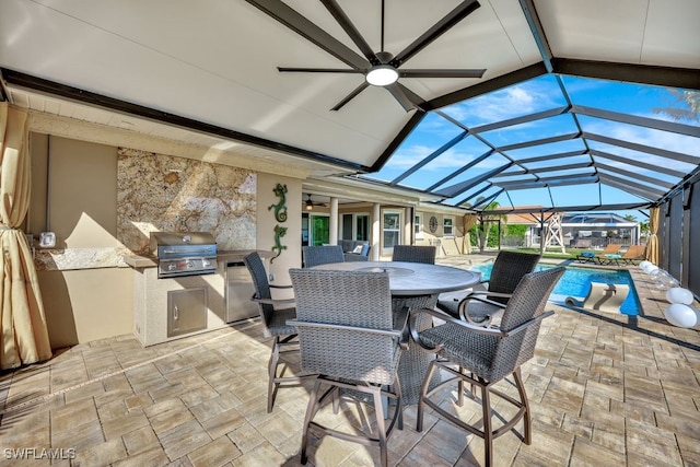 view of patio / terrace featuring exterior kitchen, a lanai, and area for grilling