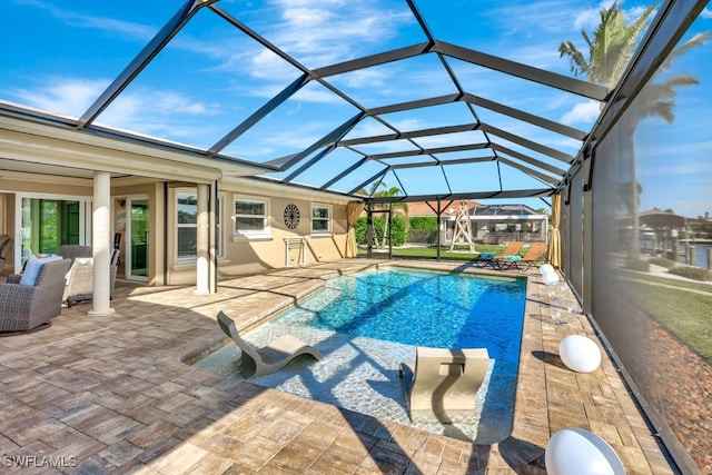 view of pool with a patio and glass enclosure