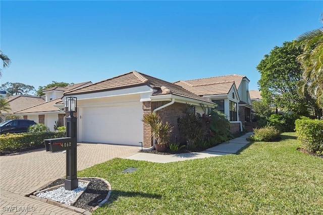 ranch-style home with a garage and a front lawn