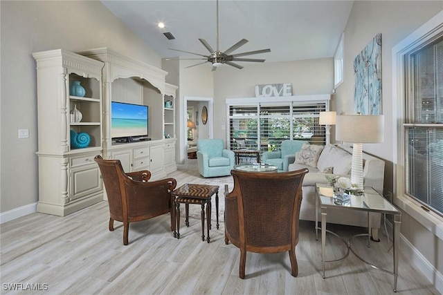 sitting room featuring ceiling fan, high vaulted ceiling, and light hardwood / wood-style flooring