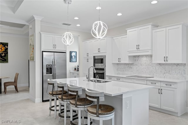 kitchen featuring visible vents, decorative backsplash, appliances with stainless steel finishes, a kitchen island with sink, and a sink