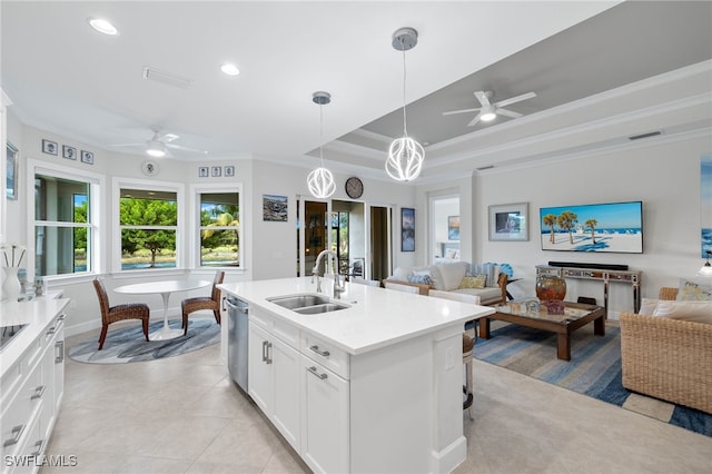 kitchen with a tray ceiling, visible vents, open floor plan, a sink, and dishwasher