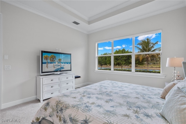 carpeted bedroom featuring visible vents, baseboards, a raised ceiling, and crown molding