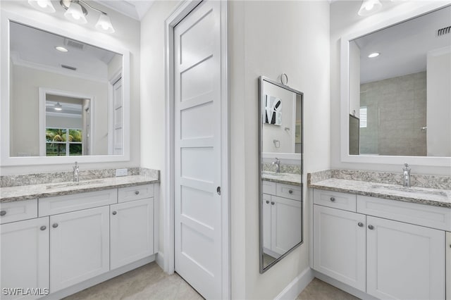 bathroom with ornamental molding, two vanities, and a sink