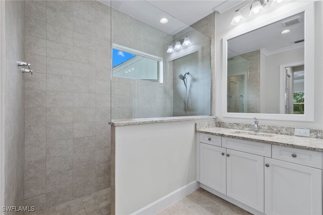 full bathroom with a walk in shower, vanity, visible vents, and crown molding