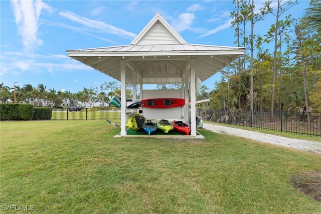 exterior space with a carport, gravel driveway, and fence