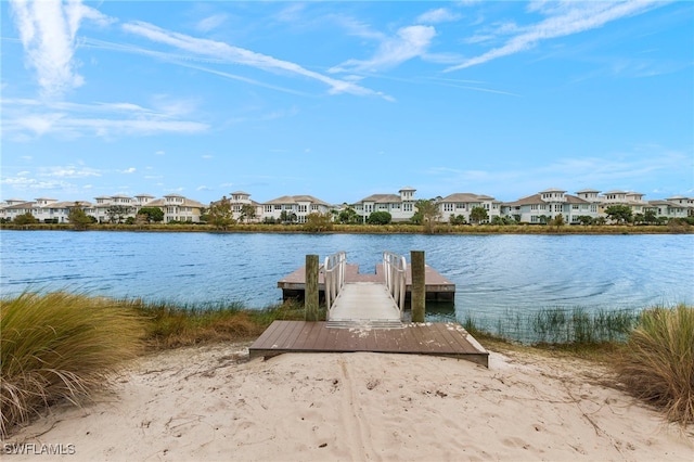 dock area featuring a water view and a residential view