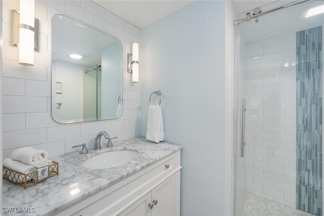 bathroom featuring vanity, an enclosed shower, and backsplash