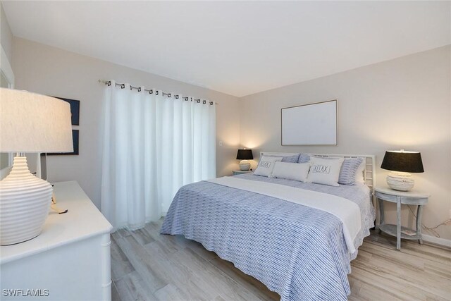 bedroom with light hardwood / wood-style flooring