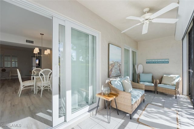 balcony with an outdoor hangout area, a patio area, and ceiling fan