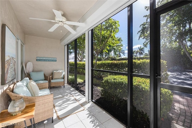 sunroom / solarium featuring ceiling fan