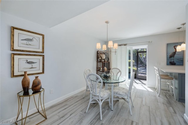 dining room with an inviting chandelier and light wood-type flooring