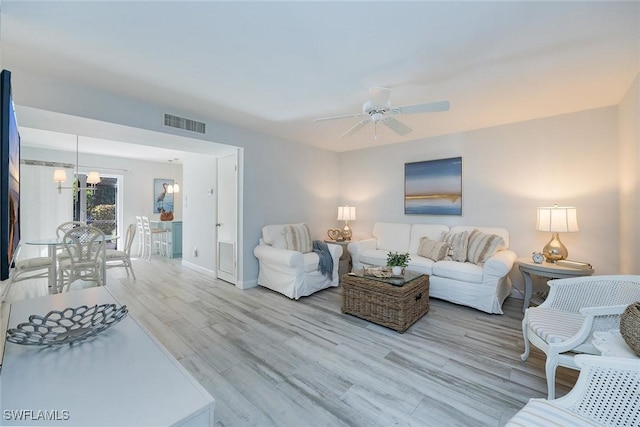 living room featuring ceiling fan and light wood-type flooring