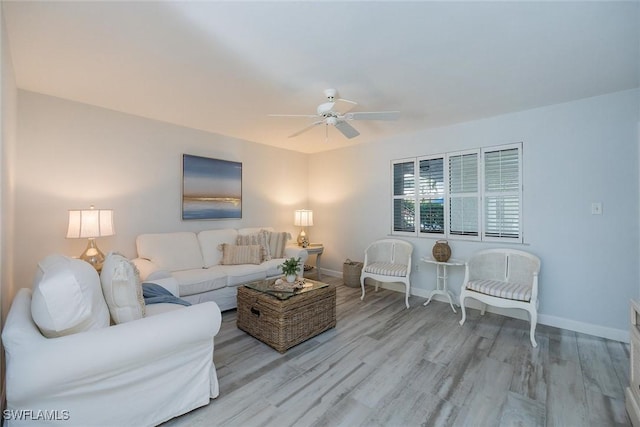 living room featuring ceiling fan and light wood-type flooring