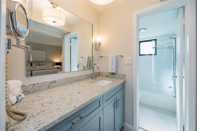 bathroom with vanity and combined bath / shower with glass door