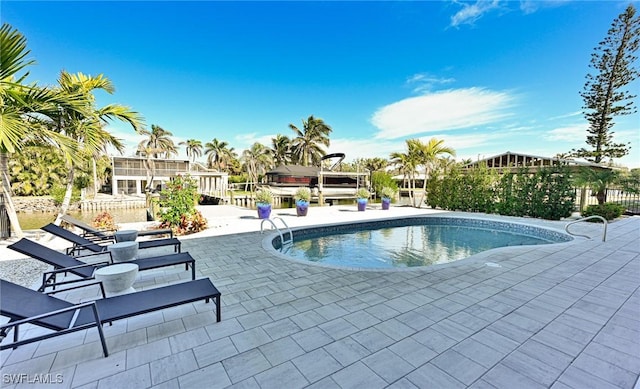 view of swimming pool with a patio