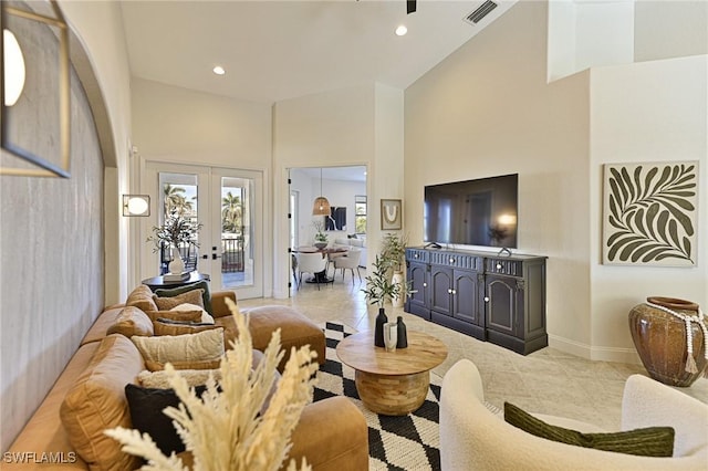 living room with light tile patterned flooring, french doors, and a high ceiling