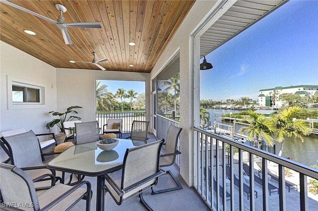 balcony featuring a water view and ceiling fan