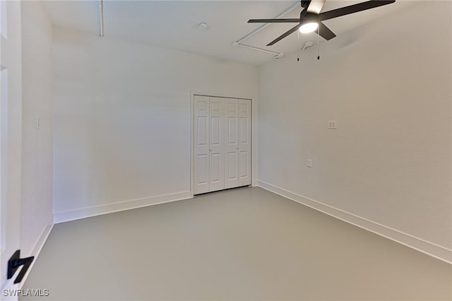 empty room with concrete flooring and ceiling fan