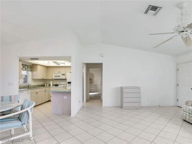 kitchen with white appliances, vaulted ceiling, ceiling fan, and light tile patterned flooring