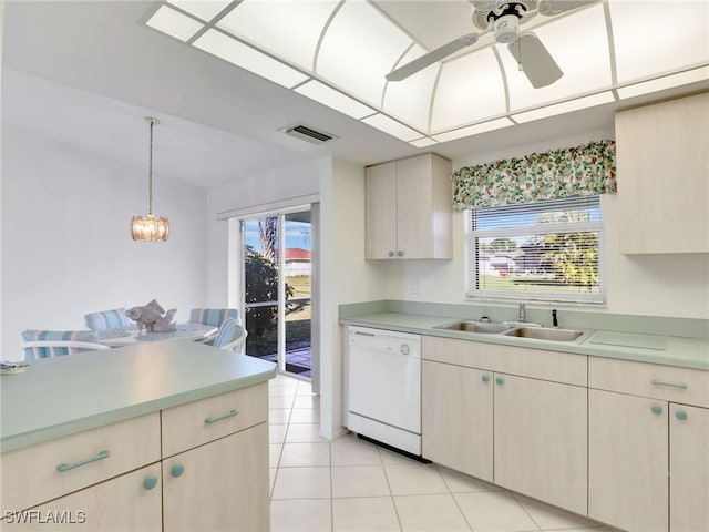 kitchen with plenty of natural light, sink, white dishwasher, and decorative light fixtures