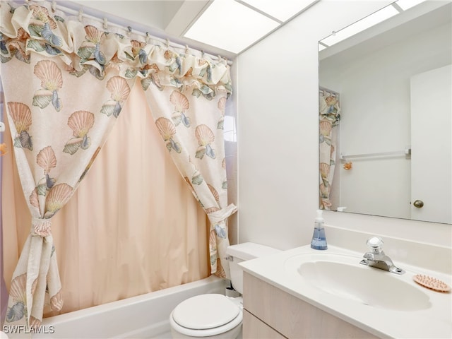 full bathroom with shower / bathtub combination with curtain, vanity, toilet, and a skylight