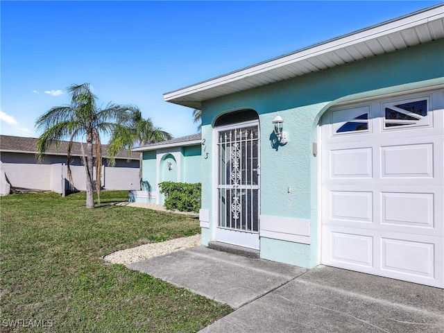 property entrance with a garage and a lawn