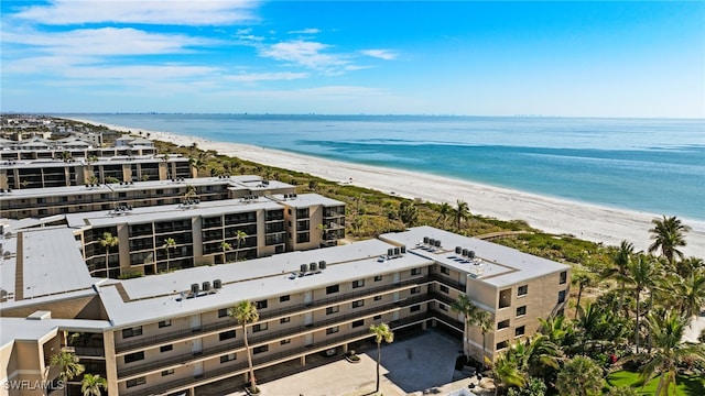 drone / aerial view with a water view and a view of the beach