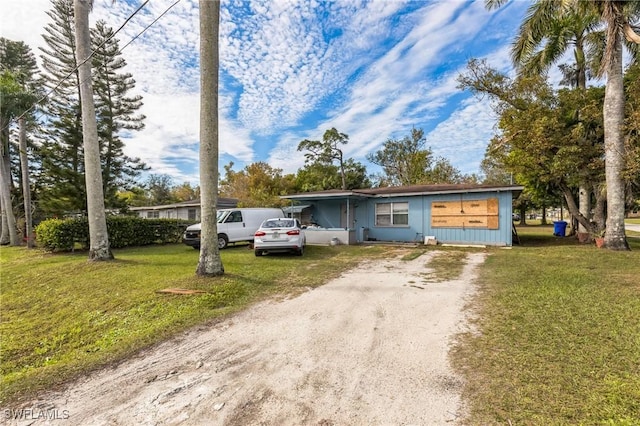 single story home with a front lawn