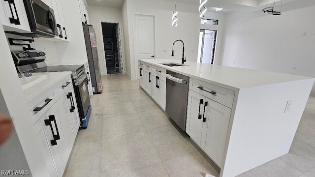 kitchen with a kitchen island with sink, sink, stainless steel appliances, and white cabinets