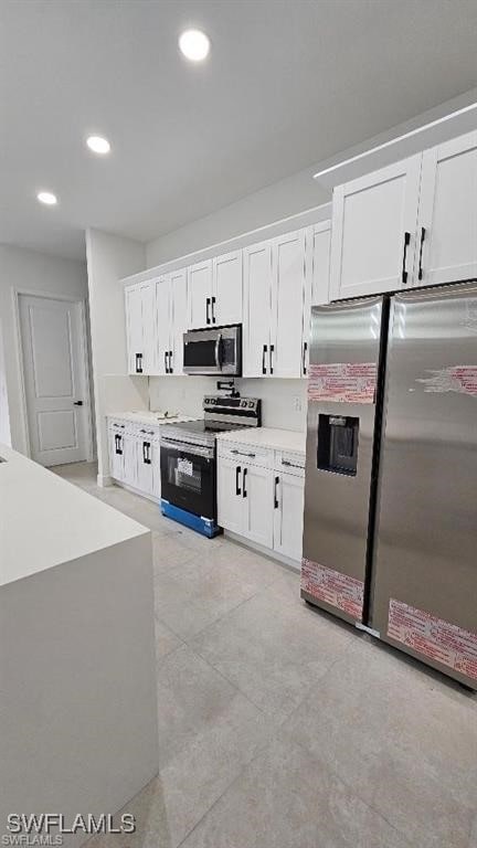 kitchen featuring stainless steel appliances and white cabinets