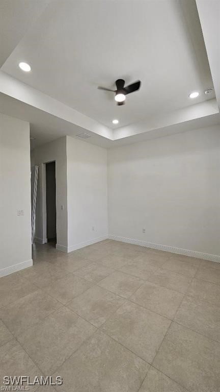 unfurnished room with a raised ceiling