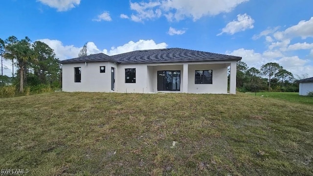 rear view of property with a yard