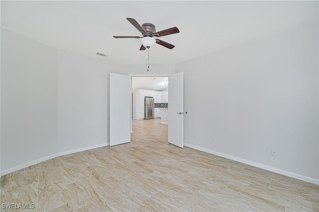 unfurnished room with ceiling fan