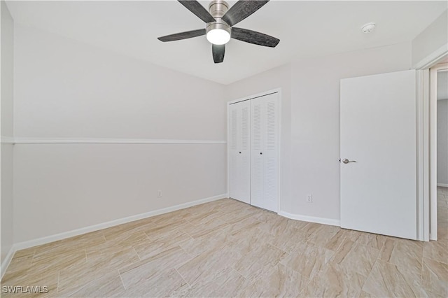 unfurnished bedroom with ceiling fan and a closet