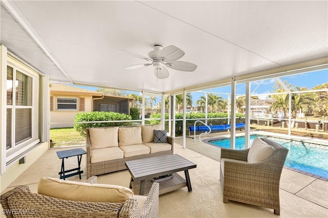 sunroom / solarium with a pool, ceiling fan, and plenty of natural light