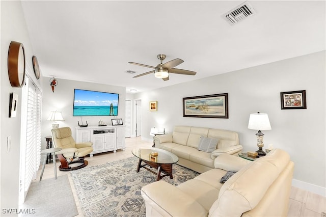 living room with ceiling fan and light wood-type flooring