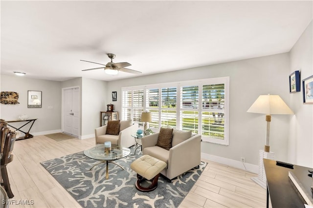 living room featuring light hardwood / wood-style floors and ceiling fan