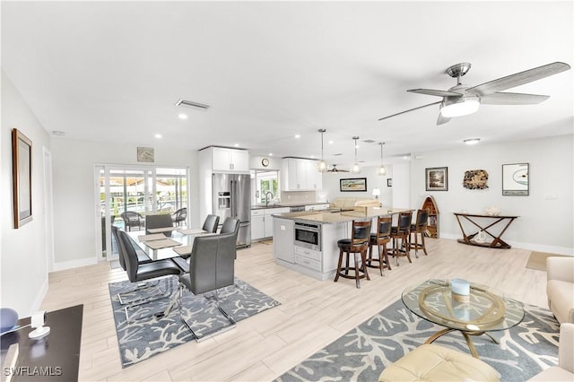 interior space with ceiling fan, light hardwood / wood-style floors, and sink