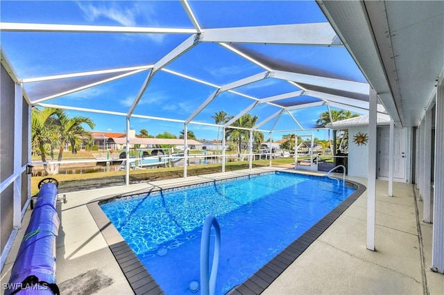 view of swimming pool featuring a lanai and a patio area